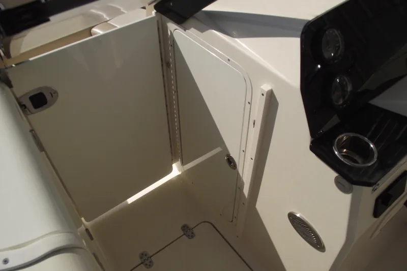 Slide: The Image of 2022 Scout 215 Dorado interior with storage compartment and control panel. - 23