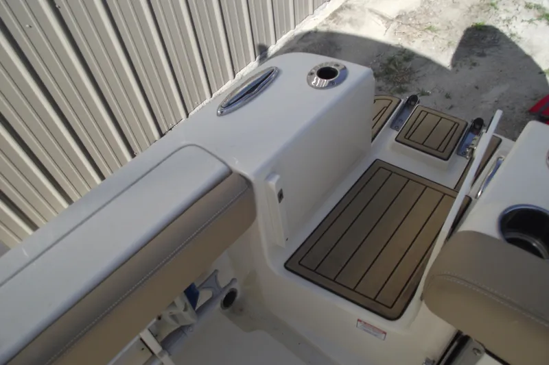 Slide: The Image of 2022 Scout 215 Dorado boat interior with cushioned seating and non-slip flooring. - 28