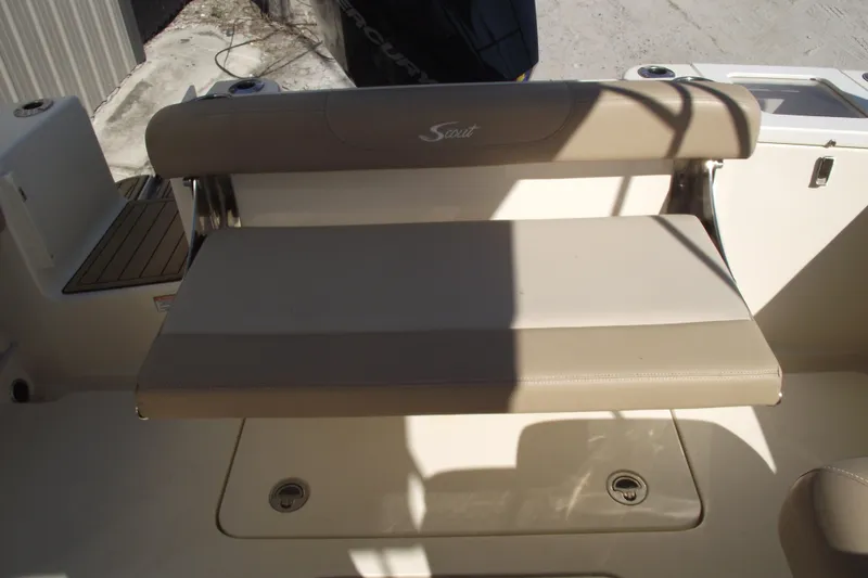 Slide: The Image of 2022 Scout 215 Dorado boat seat with beige upholstery and storage compartment. - 30