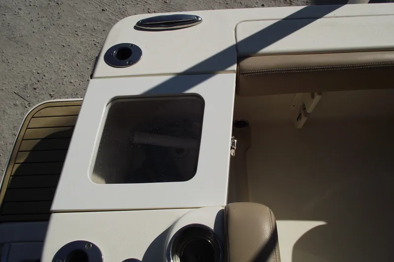 Slide: The Image of 2022 Scout 215 Dorado boat interior with storage compartment and cup holders. - 31