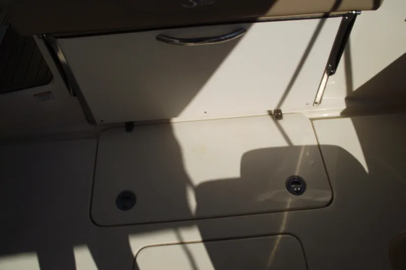 Slide: The Image of 2022 Scout 215 Dorado boat interior with storage compartments and shadows. - 33