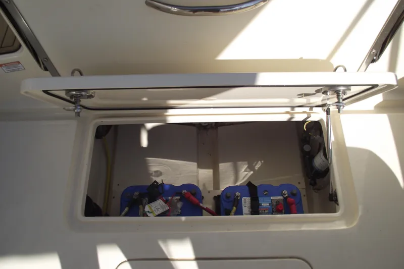 Slide: The Image of 2022 Scout 215 Dorado boat battery compartment with open hatch. - 34