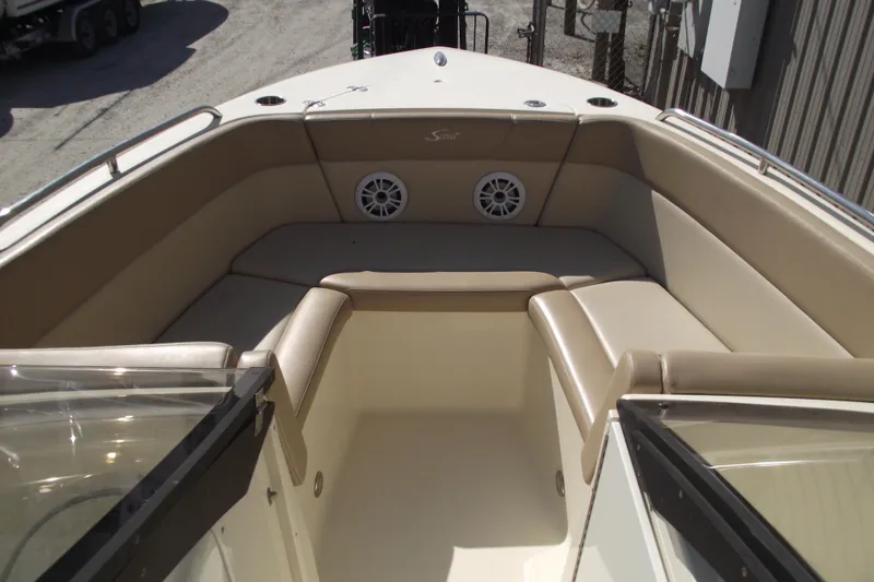 Slide: The Image of 2022 Scout 215 Dorado boat interior with beige seating and speakers. - 5