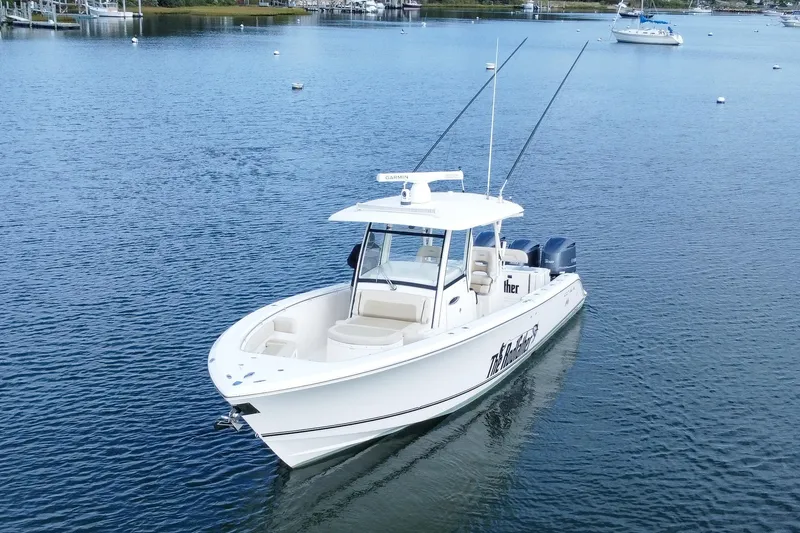 Slide: The Image of 2015 Cobia 344 Center Console boat on calm water, featuring dual engines. - 14