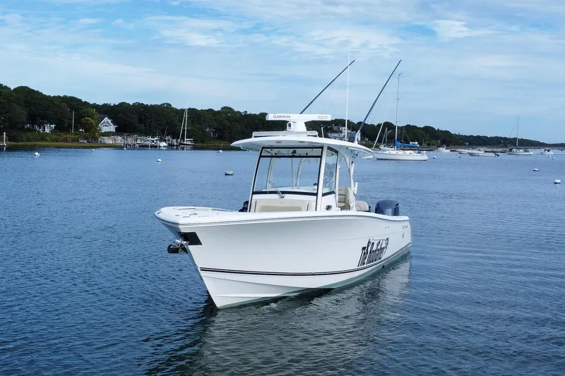 Slide: The Image of 2015 Cobia 344 Center Console boat on calm water, scenic background. - 3