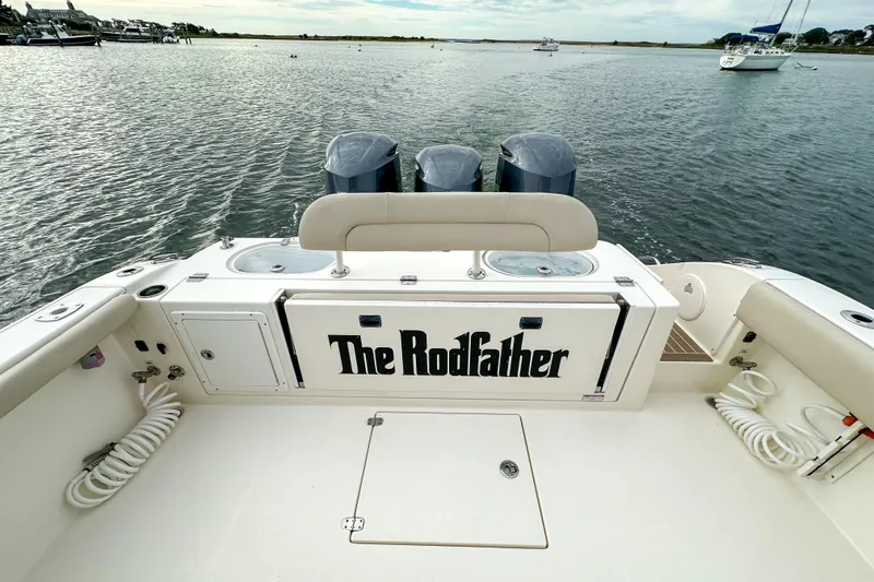 Slide: The Image of 2015 Cobia 344 Center Console boat, "The Rodfather," on calm waters with triple engines. - 35