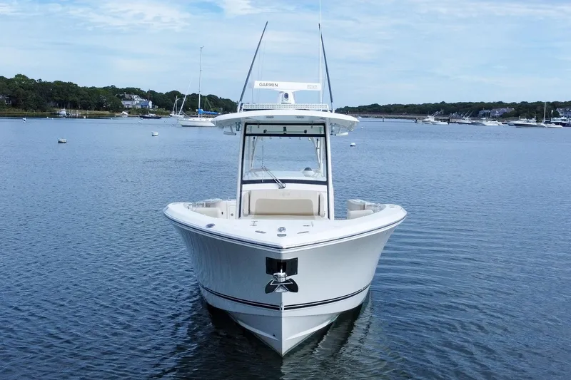 Slide: The Image of 2015 Cobia 344 Center Console boat on calm water, front view. - 4
