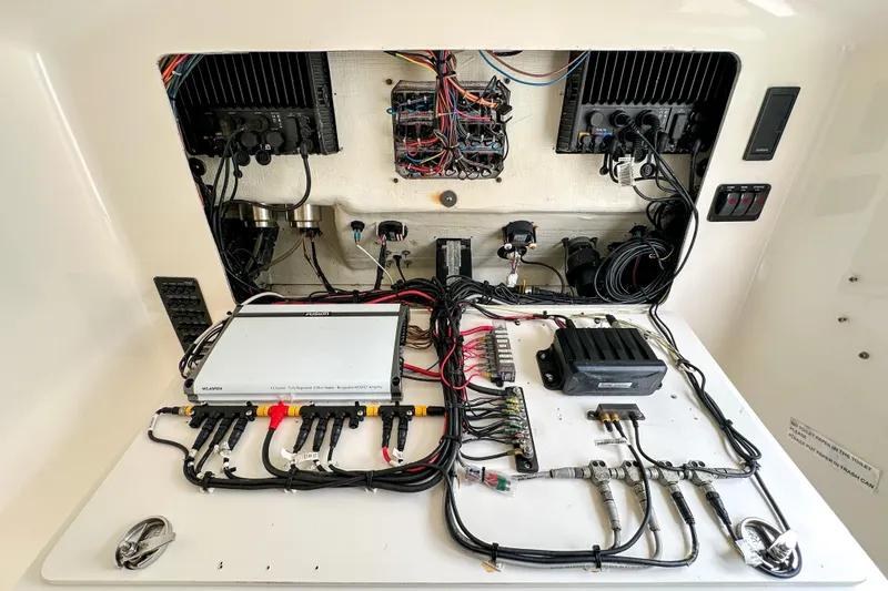 Slide: The Image of 2015 Cobia 344 Center Console boat electronics panel with wiring and components. - 47