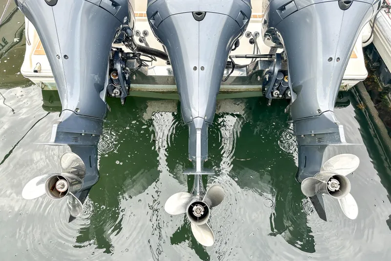 Slide: The Image of Triple outboard motors on a 2015 Cobia 344 Center Console boat. - 51