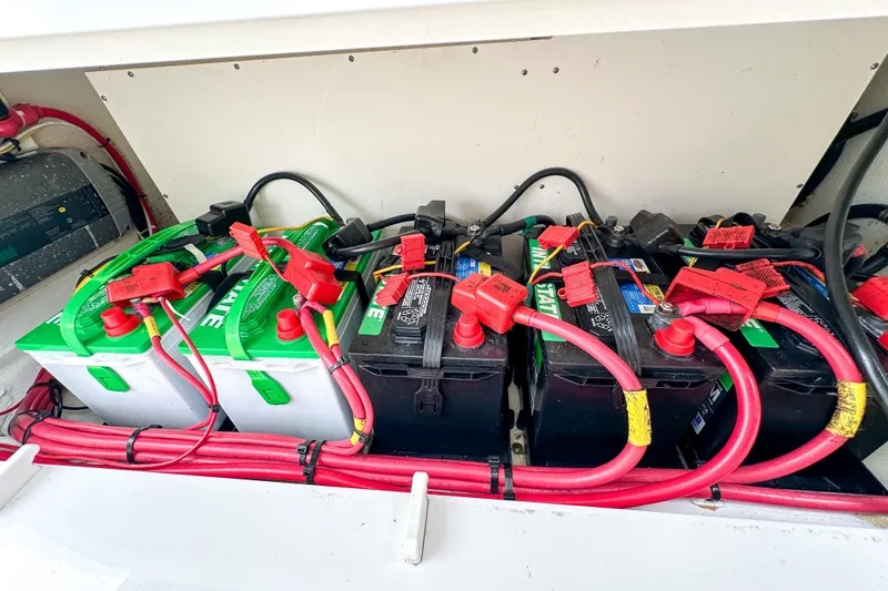 Slide: The Image of 2015 Cobia 344 Center Console boat docked at a marina under clear blue skies. - 53