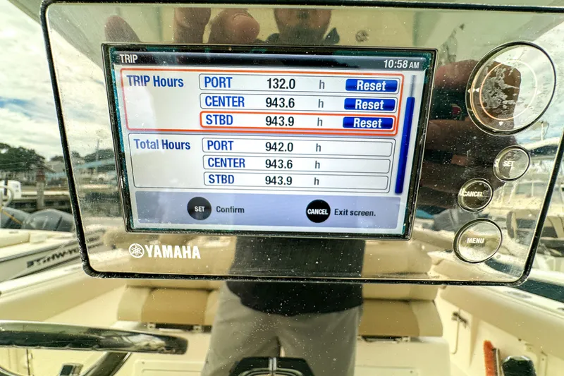 Slide: The Image of 2015 Cobia 344 Center Console boat battery setup with red cables and multiple batteries. - 54
