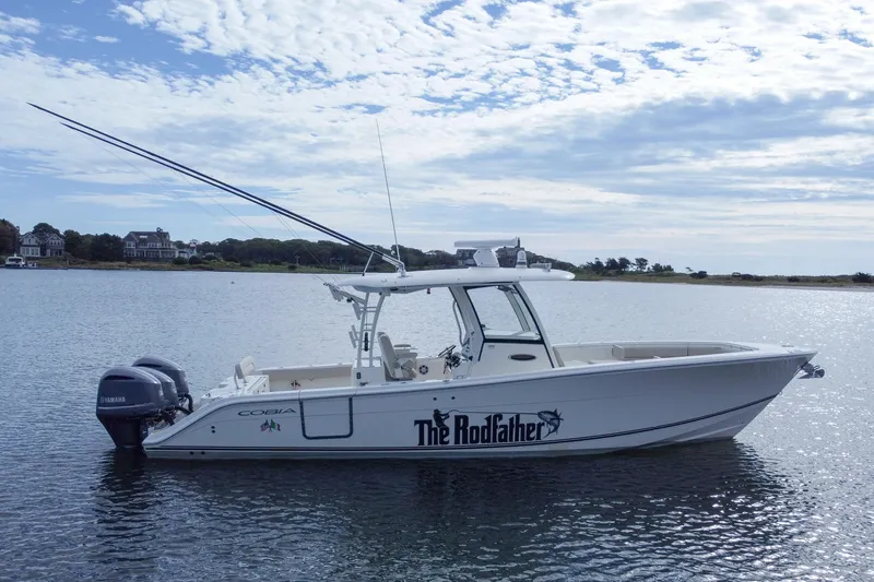 Slide: The Image of 2015 Cobia 344 Center Console boat on water, featuring "The Rodfather" text on the side. - 7