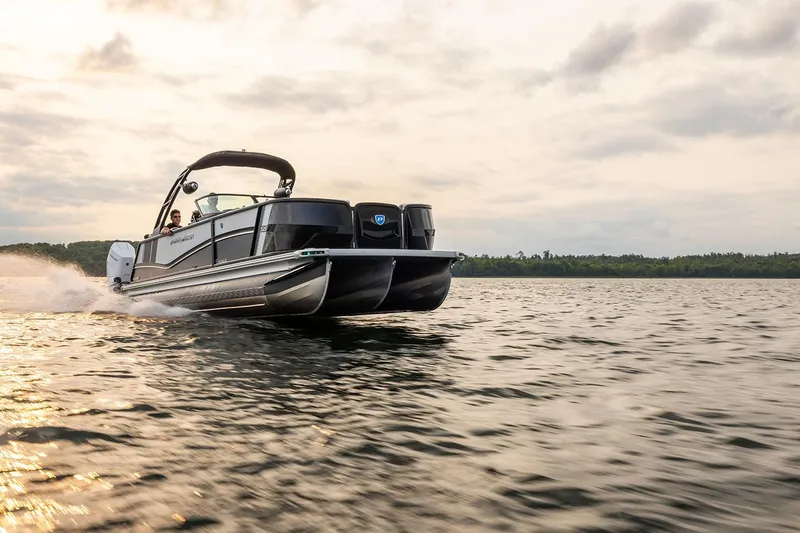 Slide: The Image of 2026 Premier 270 Super Sport boat cruising on a serene lake at sunset. - 4