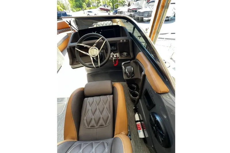 Slide: The Image of 2026 Bennington Swingback 25 boat interior with steering wheel and luxurious seating. - 7