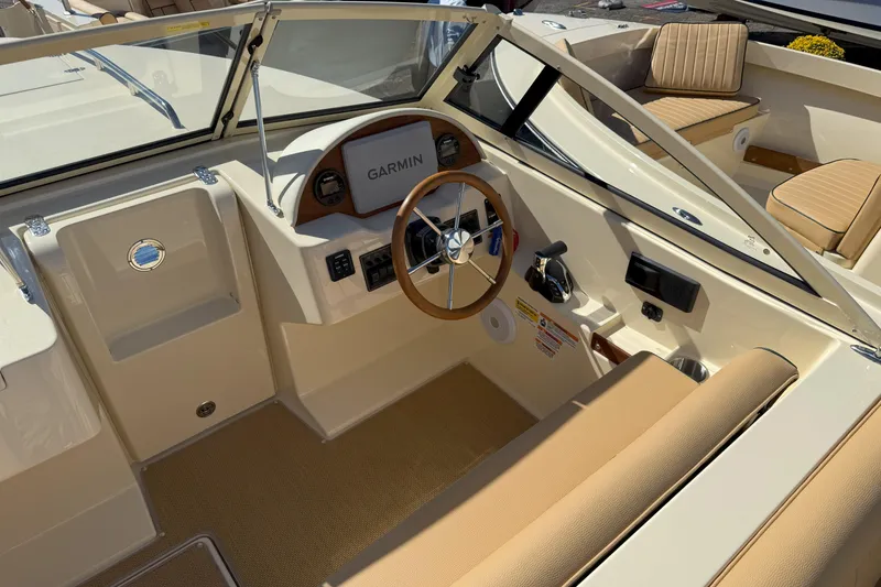Slide: The Image of 2026 Rossiter 20 Day Boat interior with Garmin navigation and tan seating. - 10