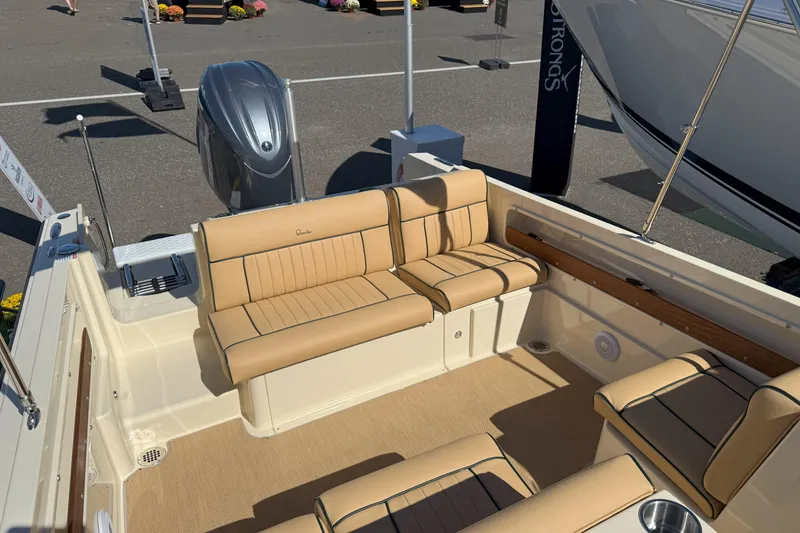 Slide: The Image of 2026 Rossiter 20 Day Boat interior with tan seating and outboard motor. - 12
