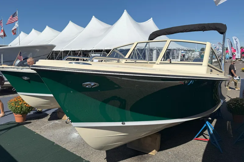 Slide: The Image of 2026 Rossiter 20 Day Boat displayed at a boat show with white tents in the background. - 4