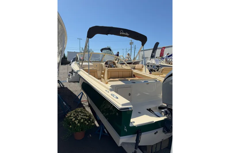 Slide: The Image of 2026 Rossiter 20 Day Boat with canopy, displayed outdoors under clear blue sky. - 5