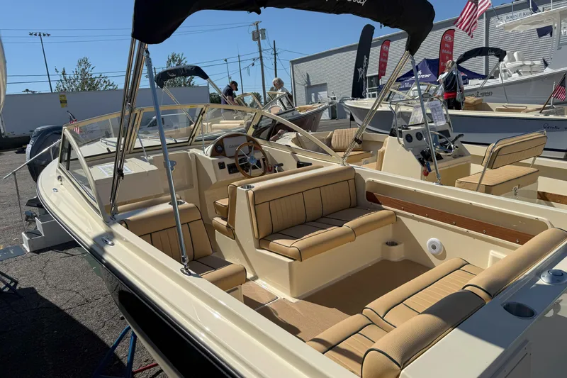 Slide: The Image of 2026 Rossiter 20 Day Boat with tan seating and sleek design on display outdoors. - 6