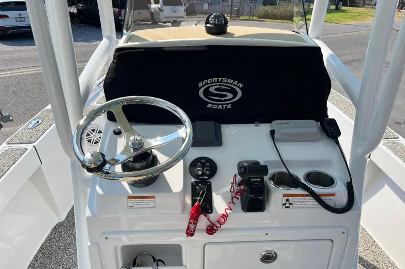 Slide: The Image of 2019 Sportsman Masters 227 Bay Boat dashboard with steering wheel and controls. - 10