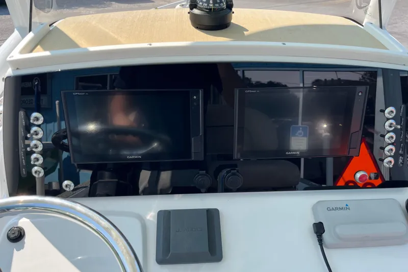 Slide: The Image of 2019 Sportsman Masters 227 Bay Boat dashboard with dual Garmin displays and controls. - 11