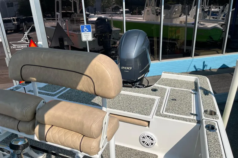 Slide: The Image of 2019 Sportsman Masters 227 Bay Boat with Yamaha 200 engine, beige seating, and deck view. - 12