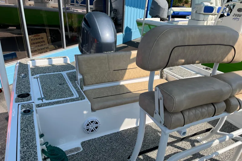 Slide: The Image of 2019 Sportsman Masters 227 Bay Boat interior with cushioned seating and motor. - 14