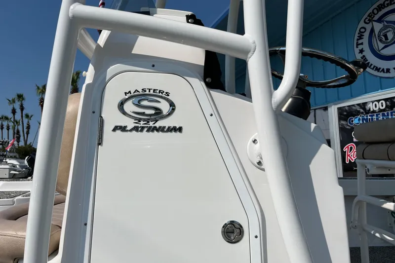 Slide: The Image of 2019 Sportsman Masters 227 Bay Boat, close-up of console and logo, outdoor dealership setting. - 15