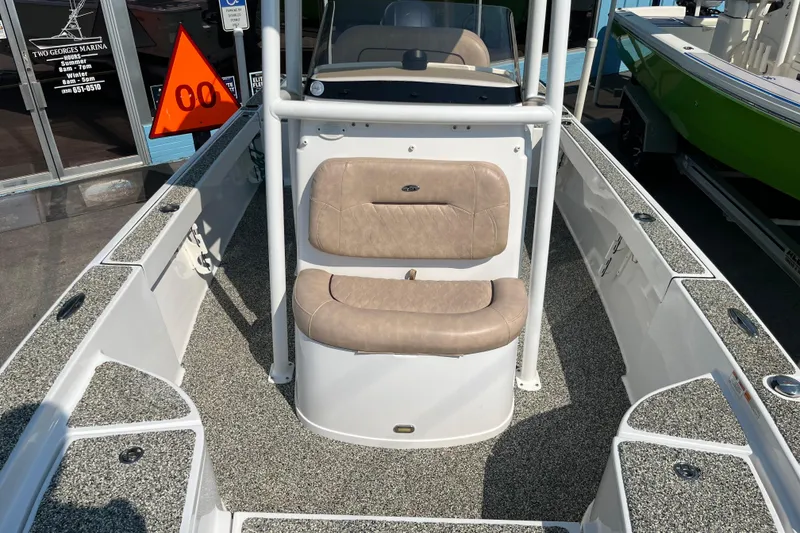 Slide: The Image of 2019 Sportsman Masters 227 Bay Boat interior with beige seating and textured flooring. - 9