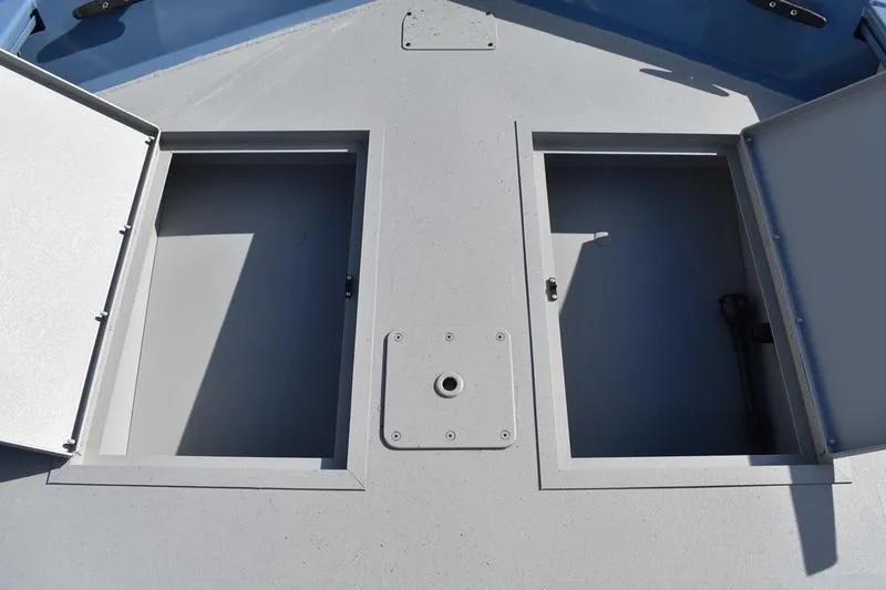 Slide: The Image of 2025 Lowe Roughneck RX1860 CC boat storage compartments with open hatches. - 11