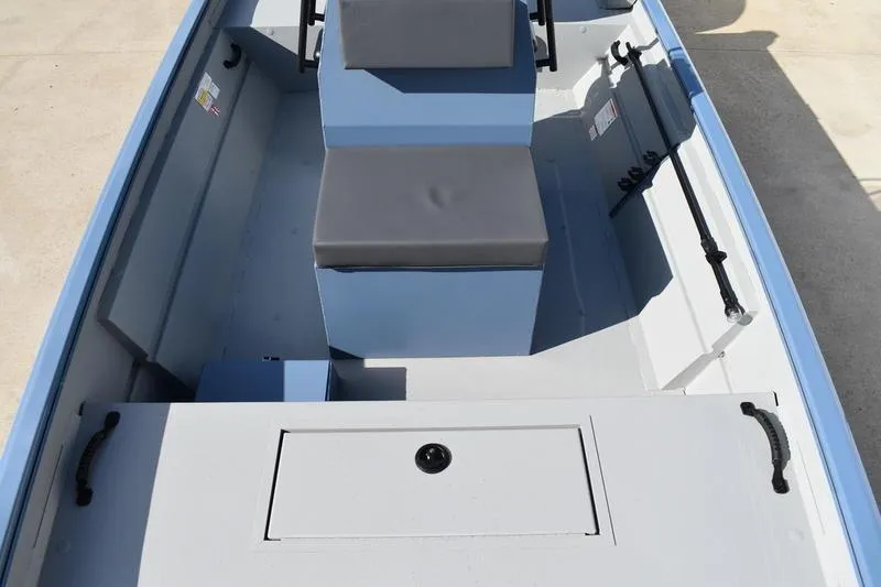 Slide: The Image of 2025 Lowe Roughneck RX1860 CC boat interior with seating and storage compartments. - 14