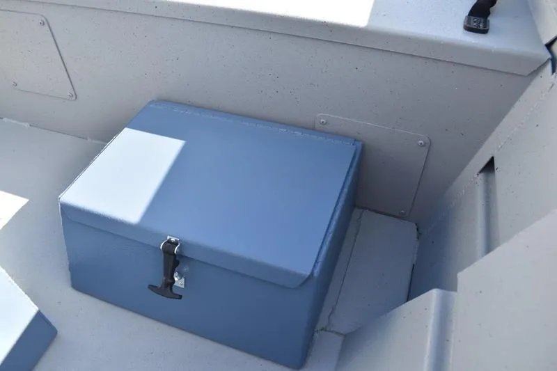 Slide: The Image of 2025 Lowe Roughneck RX1860 CC boat interior with blue storage box. - 16