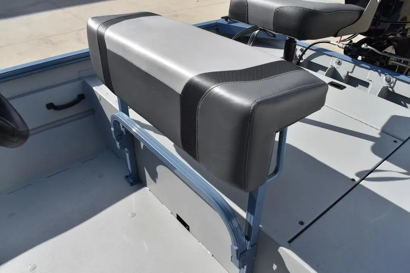 Slide: The Image of 2025 Lowe Roughneck RX1860 CC boat interior with cushioned seating and sturdy construction. - 20