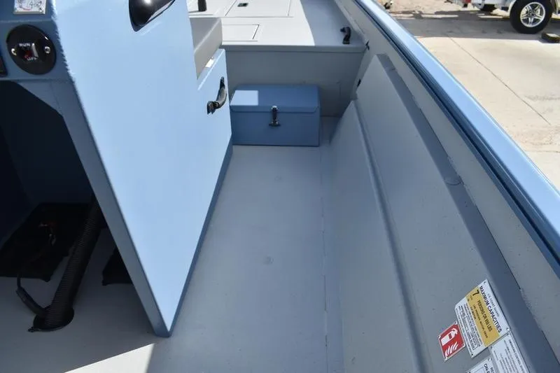 Slide: The Image of 2025 Lowe Roughneck RX1860 CC boat interior with storage compartments and control panel. - 22