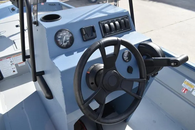 Slide: The Image of 2025 Lowe Roughneck RX1860 CC boat console with steering wheel and controls. - 23