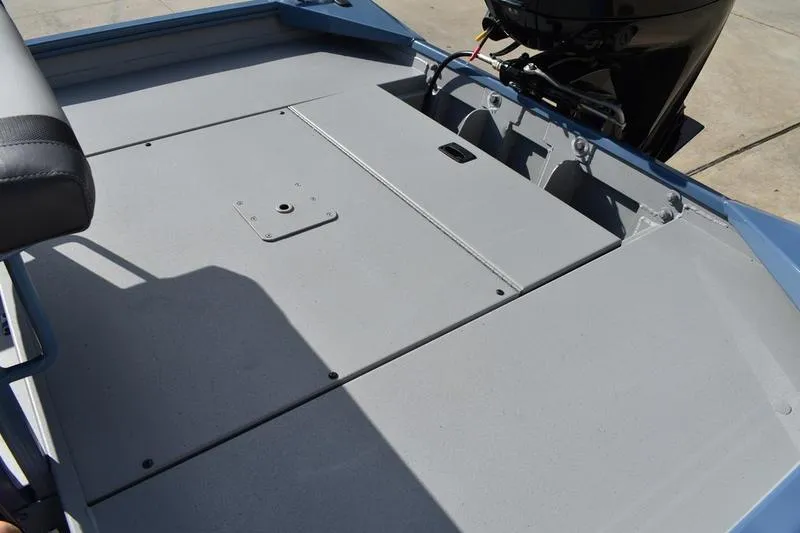 Slide: The Image of 2025 Lowe Roughneck RX1860 CC boat deck with storage compartments and motor. - 24