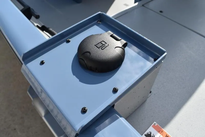 Slide: The Image of 2025 Lowe Roughneck RX1860 CC boat detail showing a black cap on a blue panel. - 26