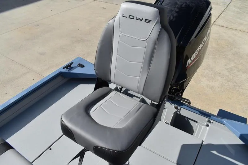 Slide: The Image of 2025 Lowe Roughneck RX1860 CC boat seat with Mercury engine in background. - 28