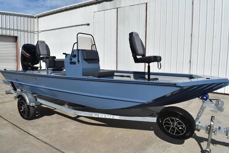 Slide: The Image of 2025 Lowe Roughneck RX1860 CC boat on trailer, parked outdoors. - 3