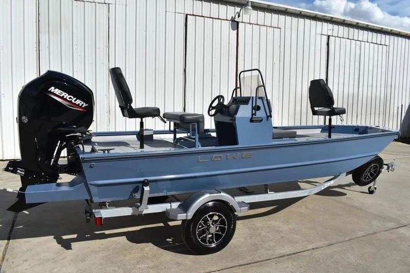 Slide: The Image of 2025 Lowe Roughneck RX1860 CC boat with Mercury engine on trailer, parked outdoors. - 5