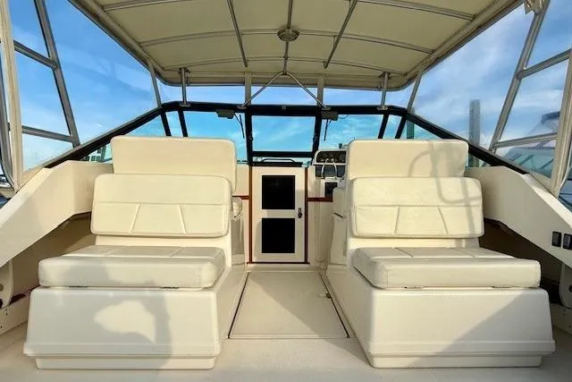 Slide: The Image of 1996 Pursuit 3100 Offshore boat docked at marina under a blue sky. - 10