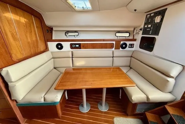 Slide: The Image of 1996 Pursuit 3100 Offshore boat interior with helm seat and marina view. - 15