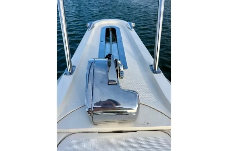 Slide: The Image of 1996 Pursuit 3100 Offshore boat named "Alexandra" docked with American flag. - 7