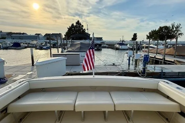 Slide: The Image of Bow of a 1996 Pursuit 3100 Offshore boat with chrome fittings on water. - 9