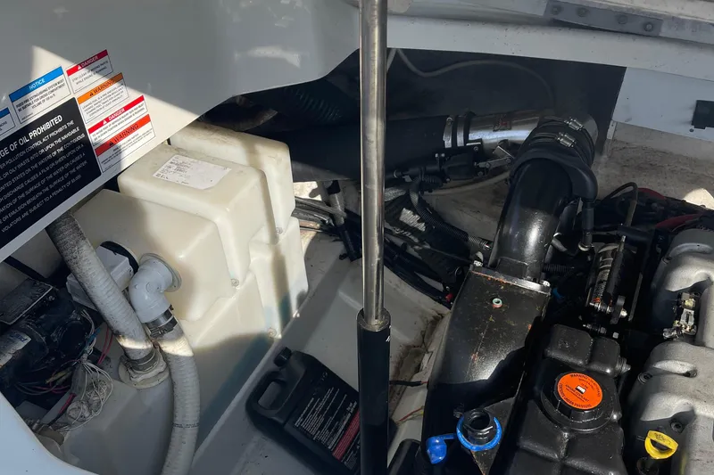 Slide: The Image of Engine compartment of a 2011 Sea Ray 270 SLX boat, showing various components and warning labels. - 10