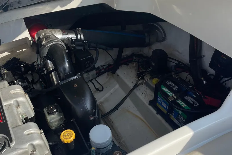 Slide: The Image of Engine compartment of a 2011 Sea Ray 270 SLX boat, showing battery and components. - 12