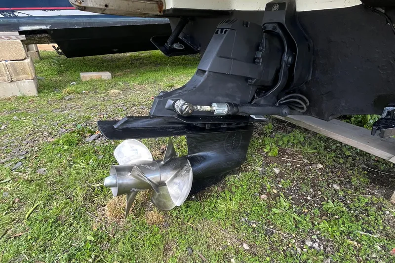 Slide: The Image of 2011 Sea Ray 270 SLX boat propeller and drive system on grassy ground. - 13