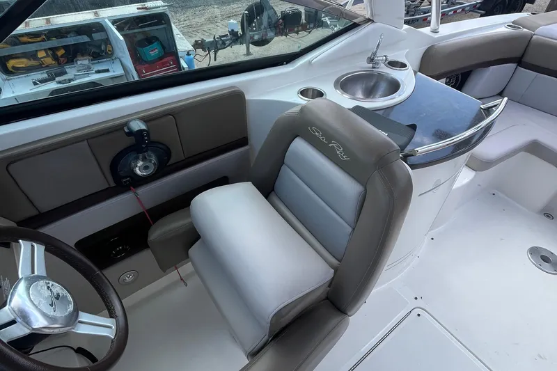 Slide: The Image of 2011 Sea Ray 270 SLX boat interior with helm, seating, and sink. - 4