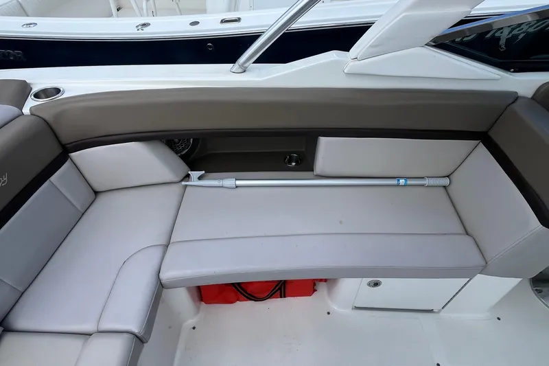 Slide: The Image of 2011 Sea Ray 270 SLX boat interior with cushioned seating and storage compartment. - 6
