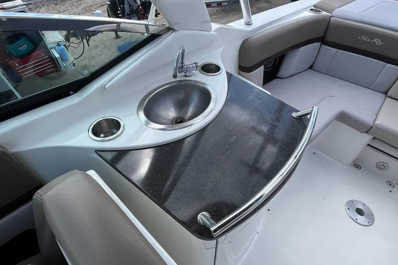 Slide: The Image of 2011 Sea Ray 270 SLX boat interior with sink and seating area. - 8